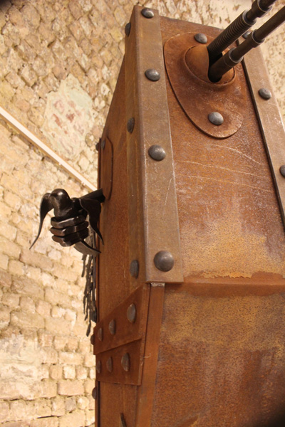 A steel sculpture of a tank/bird hybrid.