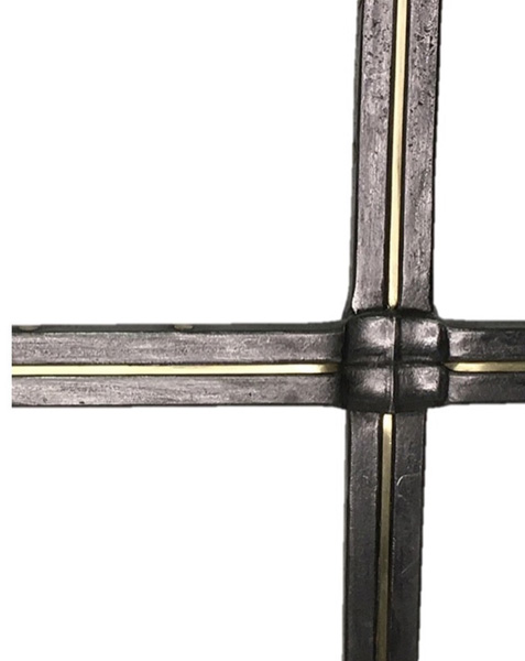 Forged steel and brass cross on a base.